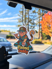 Flannel Daddy Tino car air freshener hanging inside a vehicle