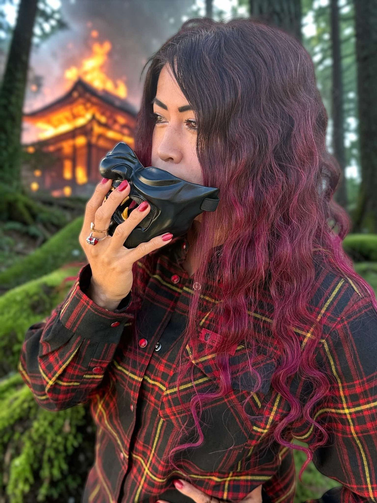 Divided Flannel Womens Hannya Flannel -  Person with purple hair holding a black shoe in front of a forest background with a building on fire.