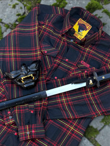 Divided Flannel Womens Hannya Flannel -  Red and black plaid shirt with samurai helmet and sword on a textured surface