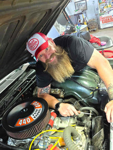 Red and white trucker worn in garage