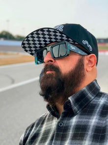 Close-up of Clutch & Throttle Speed Racer Snapback showing the checkered undervisor and side embroidery