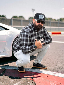 Clutch & Throttle Speed Racer Snapback worn trackside with black and white flannel