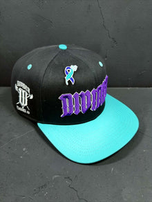 Angled view of black Divided Flannel Co. YANA snapback with teal brim