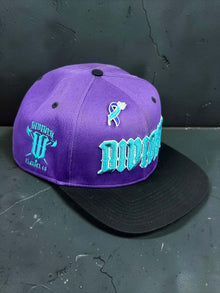Purple Divided Flannel Co. YANA snapback with black brim and teal embroidery