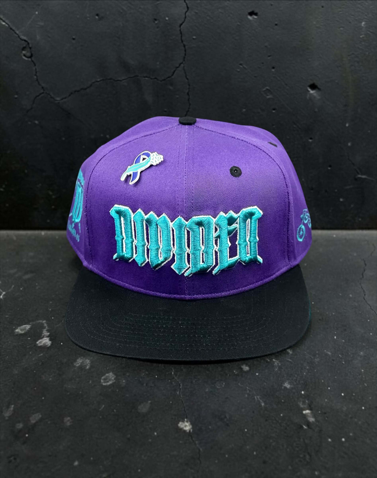 Front view of purple Divided Flannel Co. YANA snapback with black brim